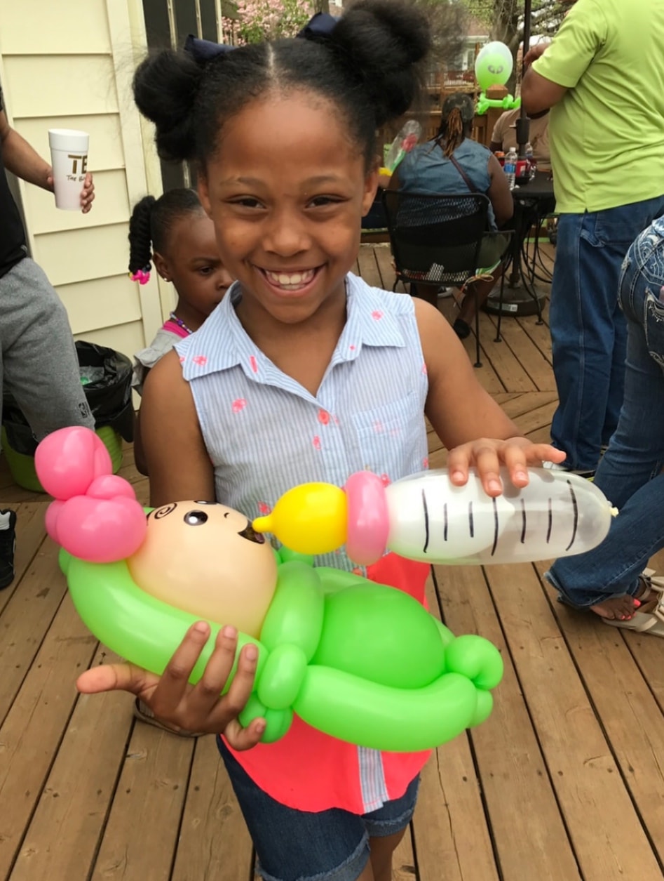 Girl hugging a mermaid balloon creation