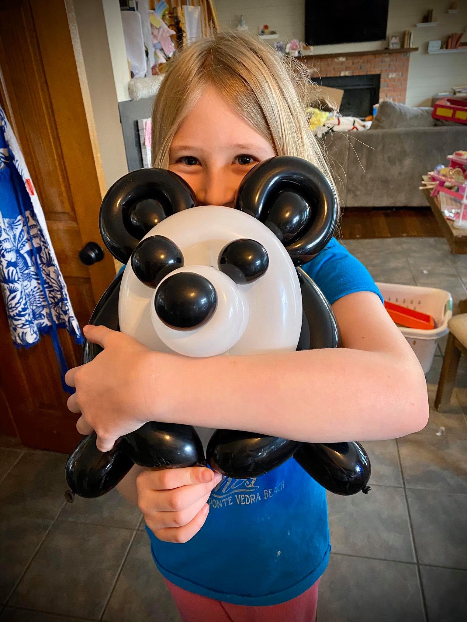 Girl holding a large panda balloon